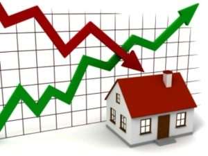Graph of market trends with a small house in the foreground, indicating real estate fluctuations.
